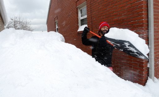 (Greg Wohlford/Erie Times-News via AP). Patrick Harden clears snow from the roof of his car on Tuesday, Dec. 26, 2017, in Erie, Pa. The National Weather Service office in Cleveland says Monday's storm brought 34 inches of snow, an all-time daily snowfa...