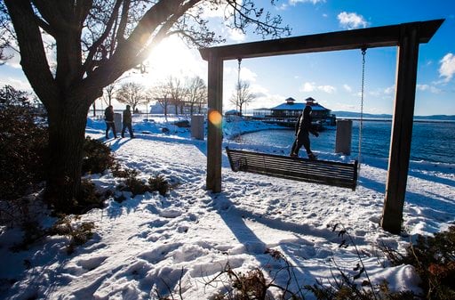 (Glenn Russell/The Burlington Free Press via AP). Pedestrians brave cold weather for a stroll along the boardwalk at Waterfront Park in Burlington, Vt., Wednesday, Dec. 27, 2017. Freezing temperatures and below-zero wind chills socked much of the north...
