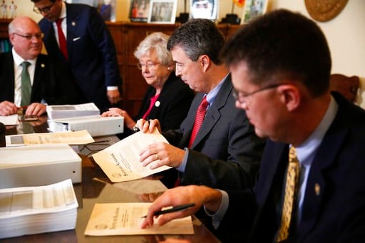 (AP Photo/Brynn Anderson). Alabama Secretary of State John Merrill, right, Alabama Gov. Kay Ivey, center, and Alabama Attorney General Steve Marshall look over documents before they certify the results of the 2017 Special Election for U.S. Senator, Thu...
