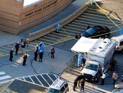 (AP Photo/Julio Cortez, File). FILE - In this Dec. 14, 2012, file photo, officials stand outside of Sandy Hook Elementary School after a shooting in Newtown, Conn. Connecticut State Police are planning to release a report assessing the agency’s respons...