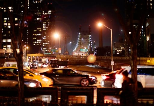 (AP Photo/Frank Franklin II). In this Jan. 11, 2018, cars and pedestrians pass the Queensboro Bridge in New York. Congestion pricing, a proposal to thin New York City's bad traffic by making part of Manhattan a toll zone is gaining momentum after years...