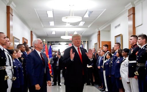 (AP Photo/Pablo Martinez Monsivais). FILE - In this July 20, 2017, file photo, President Donald Trump stops to answer a reporter's question after greeting military personnel during a visit to the Pentagon. Watching is Vice President Mike Pence. With Ru...