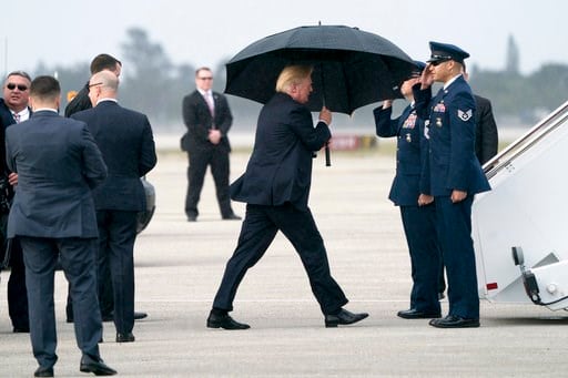 (AP Photo/Andrew Harnik). President Donald Trump boards Air Force One at Palm Beach International Airport in West Palm Beach, Fla., Monday, Jan. 15, 2018, to travel to Washington. Trump spent the holiday weekend at Mar-a-Lago, his club in Palm Beach, F...