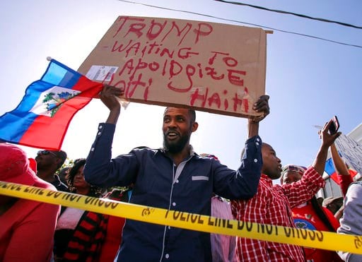 (Damon Higgins/Palm Beach Post via AP). Haitian community members protest near President Donald Trump's Mar-a-Lago estate Monday, Jan. 15, 2018, in West Palm Beach, Fla. Trump is defending himself anew against accusations that he is racist, this time a...