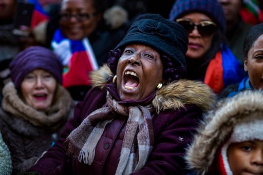 (AP Photo/Andres Kudacki). A woman shouts during a rally against racism in opposition to President Donald Trump's recent disparaging comments about Haiti and African nations in Times Square in New York, on Monday, Jan. 15, 2018.