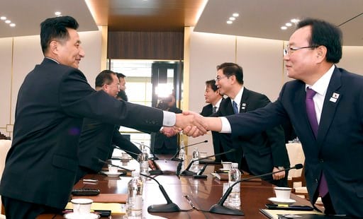 (South Korea Unification Ministry via AP). In this photo provided by South Korea Unification Ministry, South Korean Vice Unification Minister Chun Hae-sung, center right, shakes hands with the head of North Korean delegation Jon Jong Su during their me...