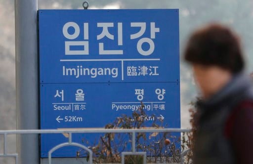 (AP Photo/Lee Jin-man). A woman walks by a signboard showing the distance to North Korea's capital Pyongyang and to South Korea's capital Seoul from Imjingang Station in Paju, South Korea, Wednesday, Jan. 17, 2018. The two Koreas are meeting Wednesday ...