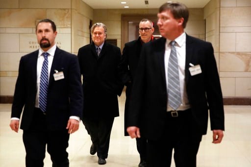 (AP Photo/Jacquelyn Martin). Former White House strategist Steve Bannon, second from left, is escorted from a House Intelligence Committee meeting where he was interviewed behind closed doors on Capitol Hill, Tuesday, Jan. 16, 2018, in Washington.