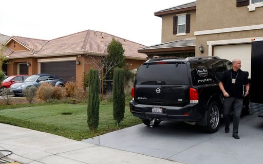 (AP Photo/Alex Gallardo). Detective walks next to a home Tuesday, Jan. 16, 2018, where police arrested a couple on Sunday accused of holding 13 children captive, in Perris, Calif.
