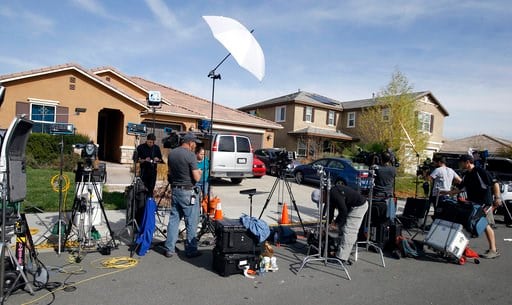 (AP Photo/Alex Gallardo). Members of the media work outside a home Tuesday, Jan. 16, 2018, where police arrested a couple on Sunday accused of holding 13 children captive, in Perris, Calif. Authorities said an emaciated teenager led deputies to the Cal...