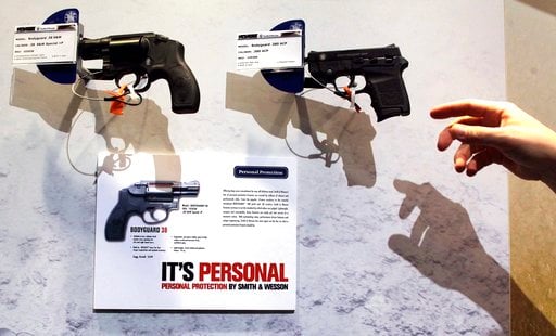 (AP Photo/Julie Jacobson, file). Smith & Wesson hand guns hang on display at the Shooting, Hunting and Outdoor Trade show, Tuesday, Jan. 18, 2011 in Las Vegas.