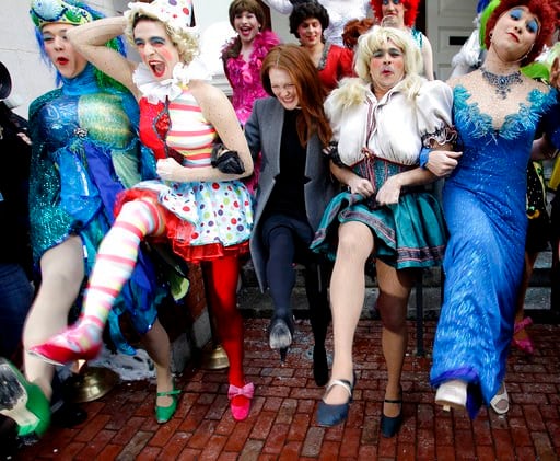 (AP Photo/Stephan Savoia, File). FILE - In this Jan. 27, 2011 file photo, actress Julianne Moore, center, named Harvard University's Hasty Pudding Theatricals woman of the year, dances in a kickline with male cast members dressed as women, on the steps...