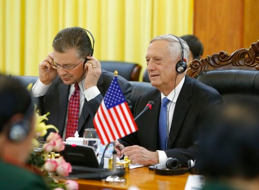 (AP Photo/Tran Van Minh). U.S. Defense Secretary Jim Mattis, right, speaks during talks with his Vietnamese counterpart Ngo Xuan Lich (not in picture) as U.S. Ambassador Danial Kritenbrink, left, adjusts his headphones in Hanoi, Vietnam, Thursday, Jan....