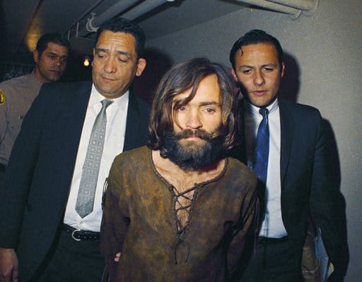 (AP Photo, File). FILE - In this 1969 file photo, Charles Manson is escorted to his arraignment on conspiracy-murder charges in connection with the Sharon Tate murder case. A Los Angeles judge on Friday, Jan. 26, 2018, will hear arguments on what count...
