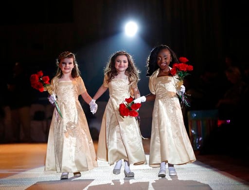(AP Photo/Gerald Herbert). The ladies in waiting of the royal court of the Krewe of Little Rascals walk for the audience during their Mardi Gras Ball in Kenner, La., Thursday, Jan. 25, 2018. The more than 200 kids riding in Sunday’s Mardi Gras parade p...