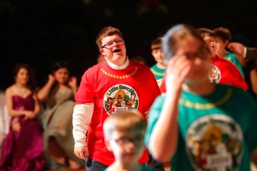 (AP Photo/Gerald Herbert). A student who is a float rider laughs as he walks with other youths past the audience during the Little Rascals Mardi Gras Ball in Kenner, La., Thursday, Jan. 25, 2018. The more than 200 kids riding in Sunday’s parade partici...