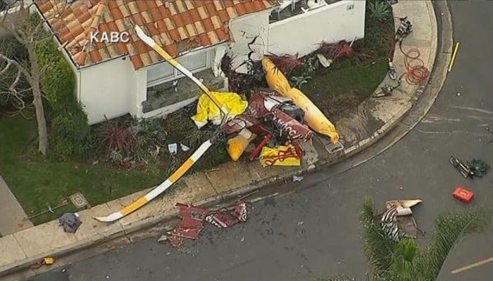 Authorities say three people are dead after a small helicopter crashed into a home near a Southern California airport. (Source: KABC/CNN)