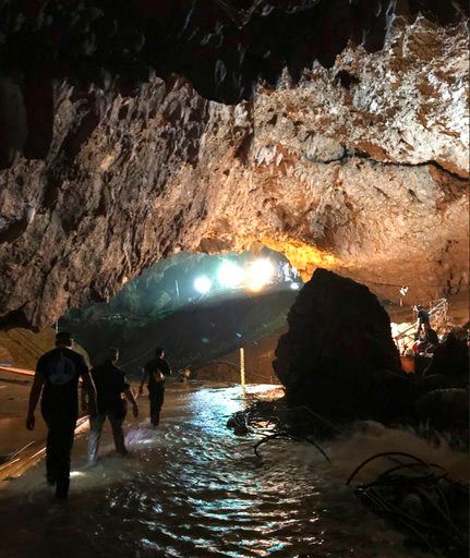 The Latest: Medic, divers who stayed with boys leave cave